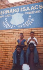 Khumbulani and Bongani, sitting on the shoulders of Children of Fire volunteers Collen Mudau and Aron Stout